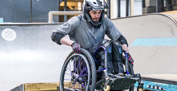 Photo shows Marcus competing in a wheelchair motorsport competition.