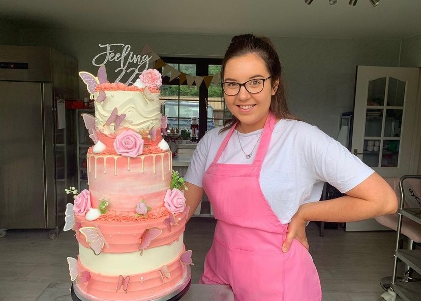 Josie Milicevic poses with one of her celebration cakes