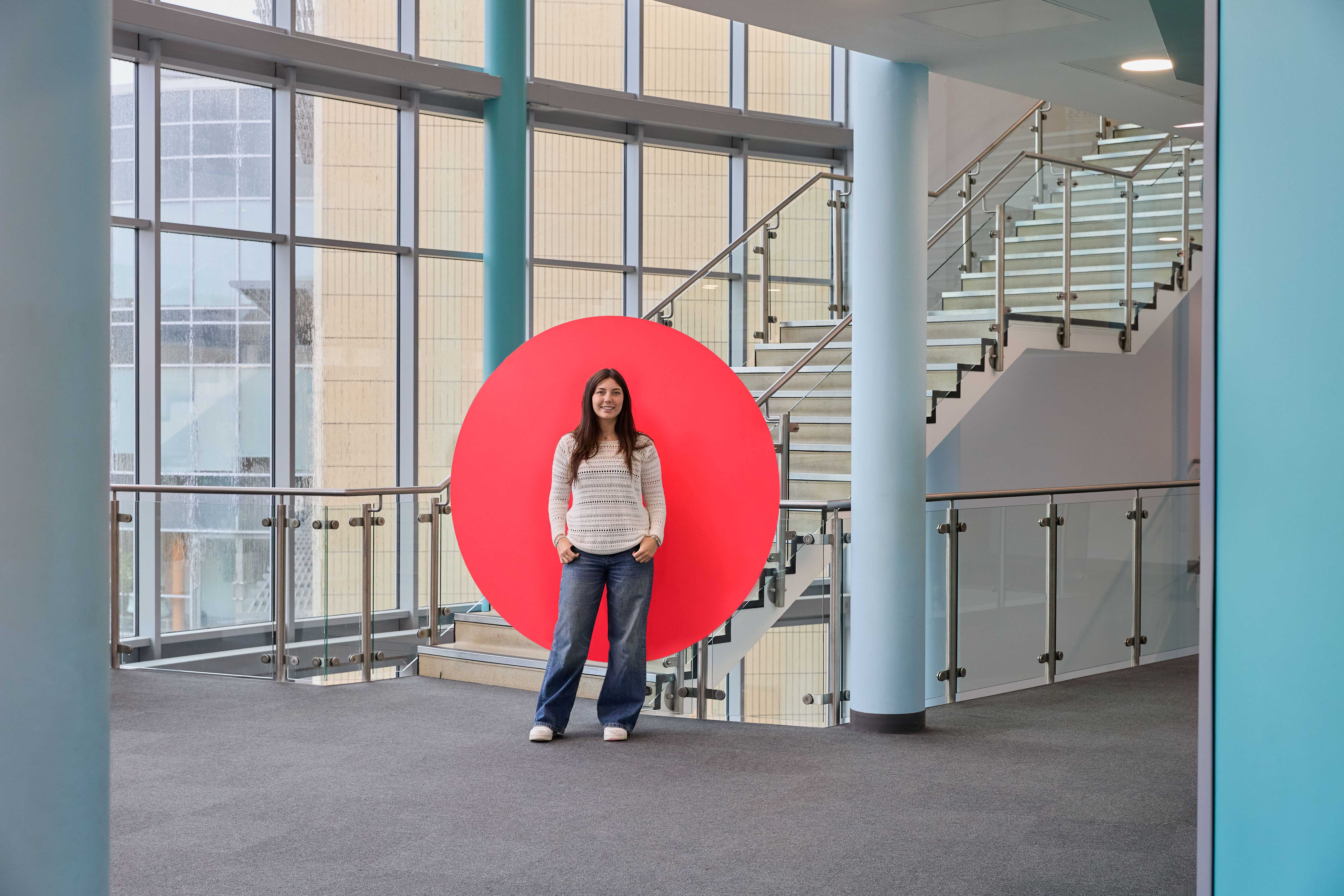 Image shows one student smiling to camera.