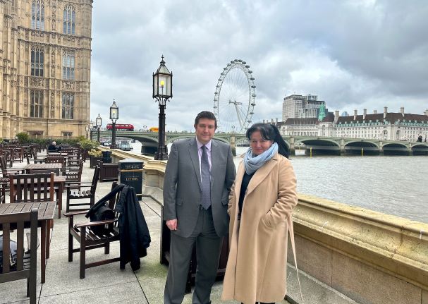 CEO and Principal Pat Brennan-Barrett poses with Andrew Lewer MP outside the Houses of Parliament in London.