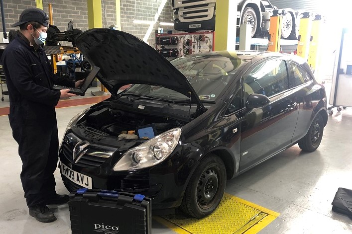 Student working on car with equipment donated by Auto Spares