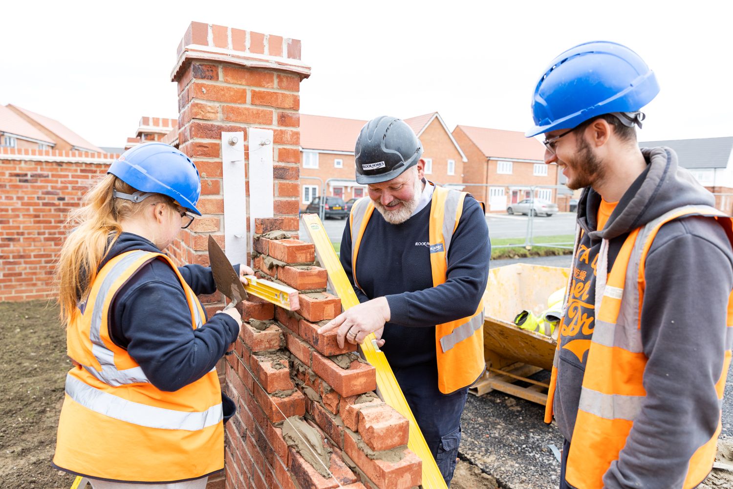 Employer and apprentices reviewing some work on a building site. 