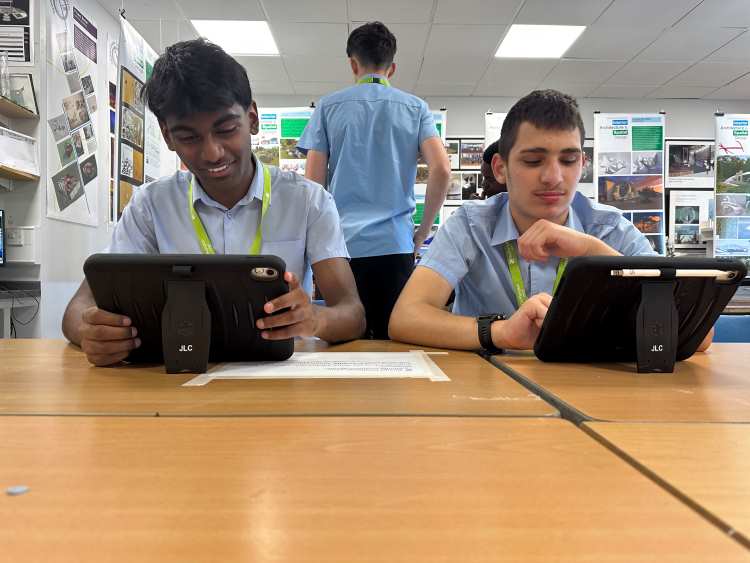 Image shows two students from The Duston School playing on tablets at the event.