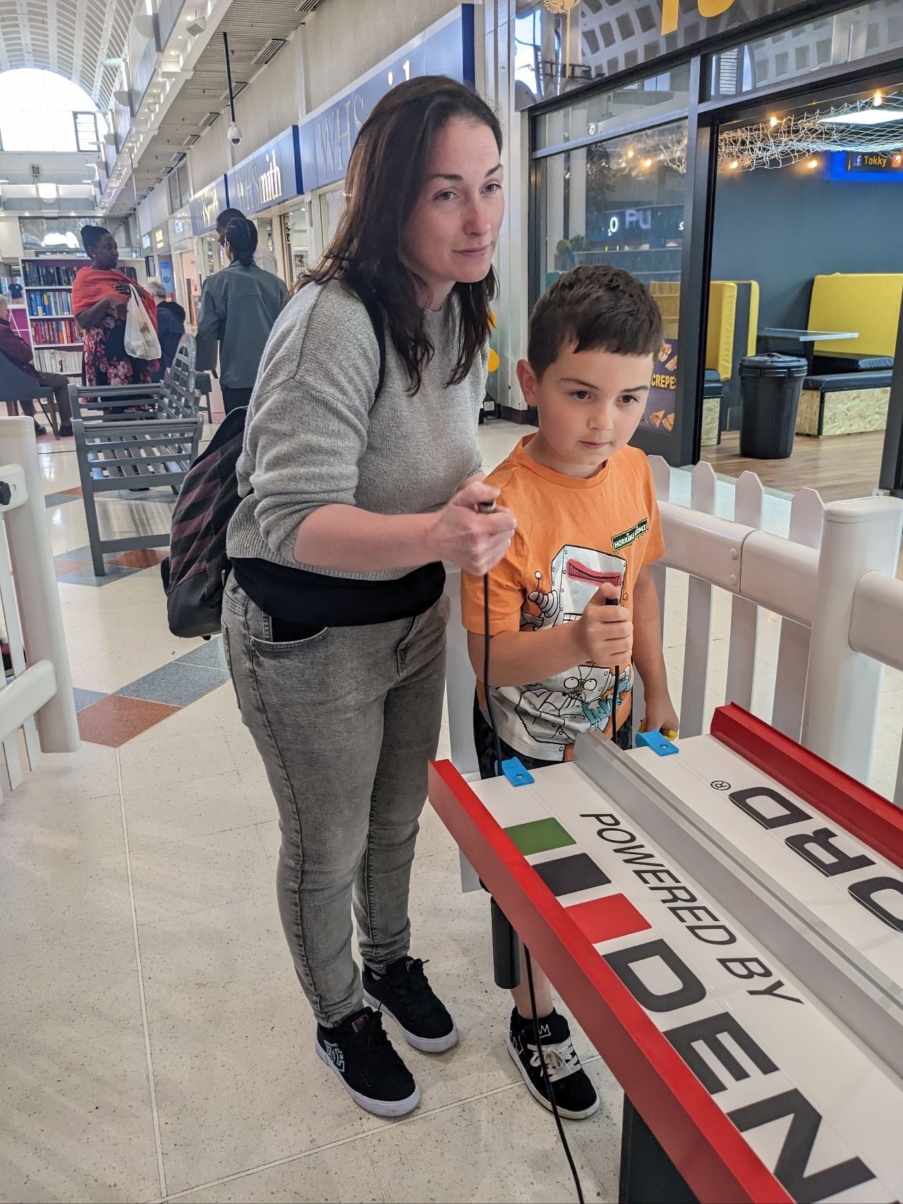 Shoppers at Weston Favell Shopping Centre having a go on the F1 in Schools race track.