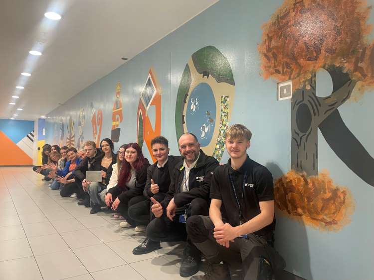 Northampton College staff and students with the mural