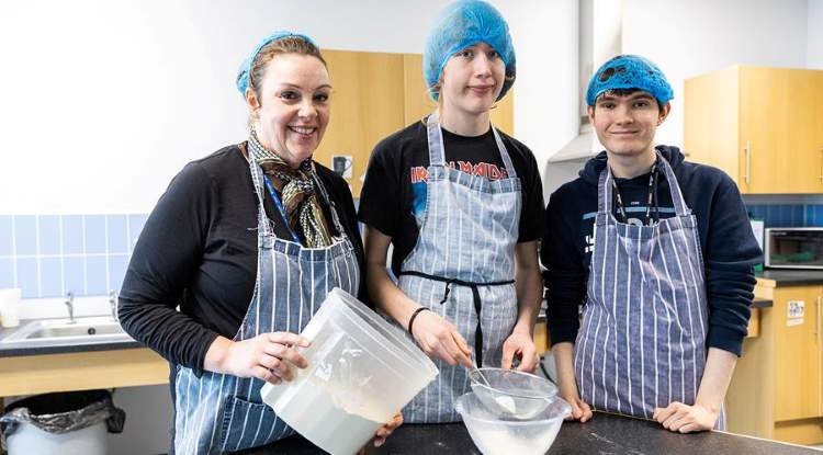 Students pose in the kitchens at Booth Lane.