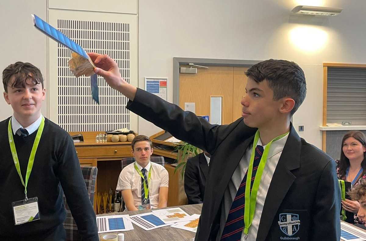 School students pose with their self-made satelites.