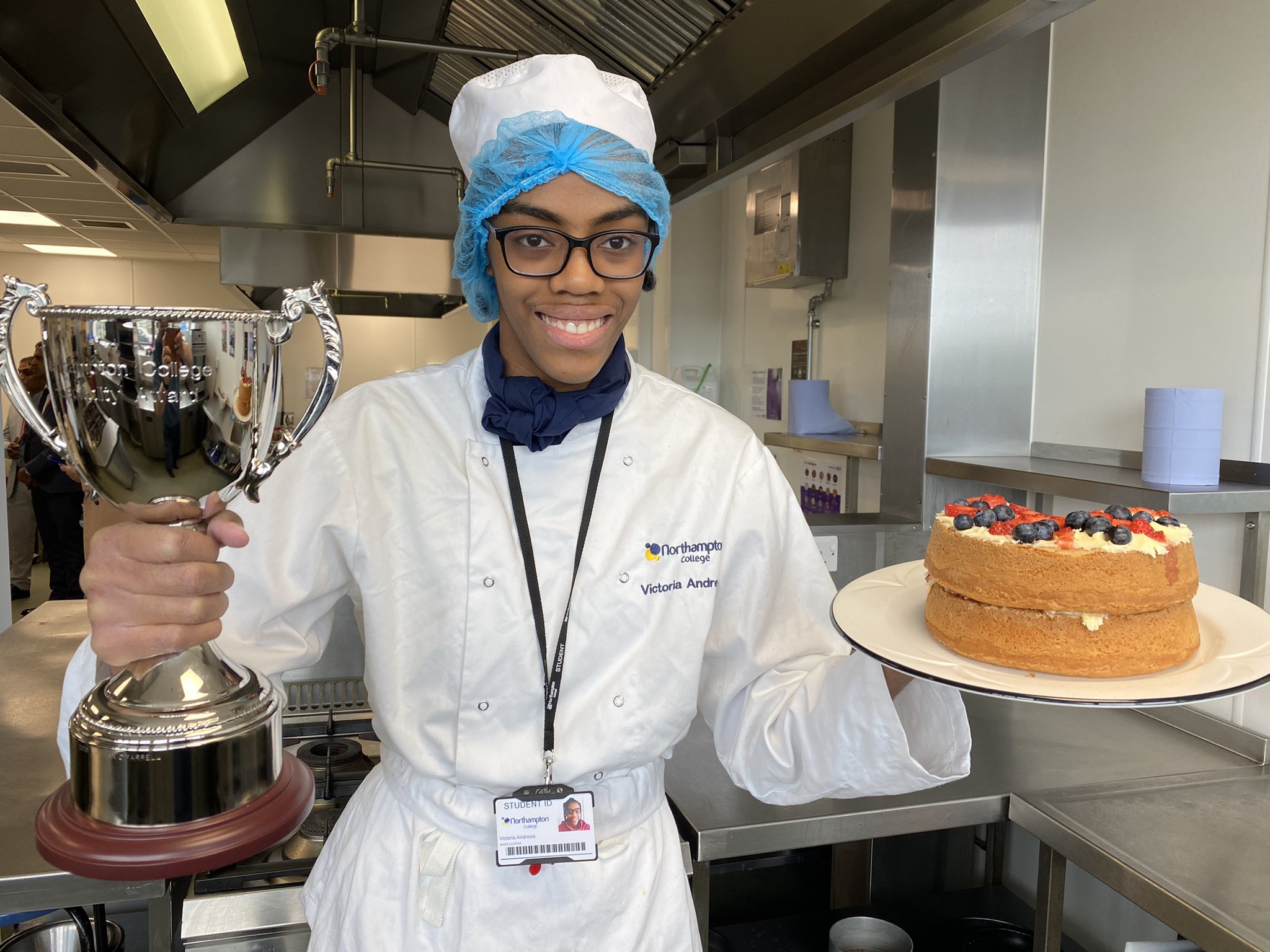 Winner Victoria poses with her trophy and winning cake