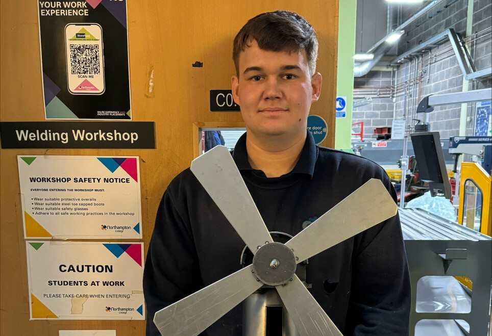 Daniel McMillan poses with a piece of his work.