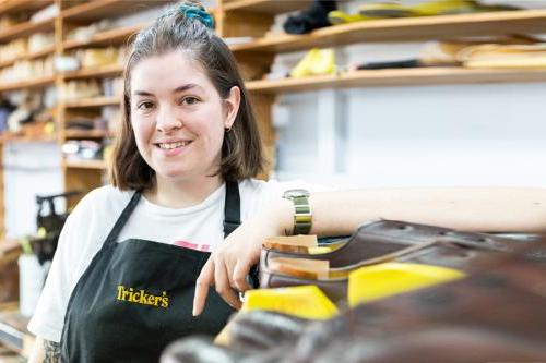 Female footwear student poses in workshop