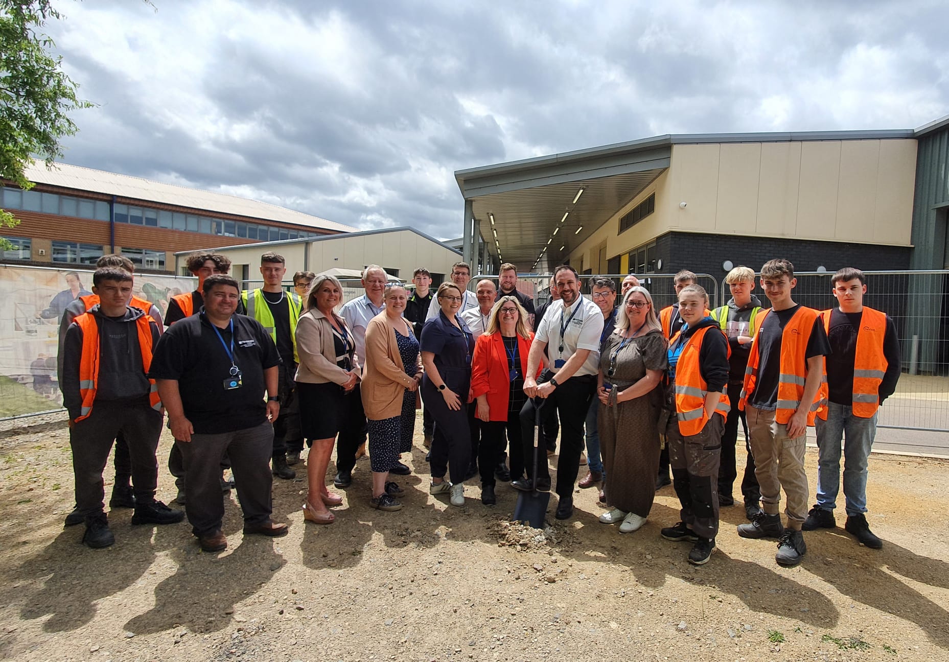 Construction students pose at the site of the new eco-classroom