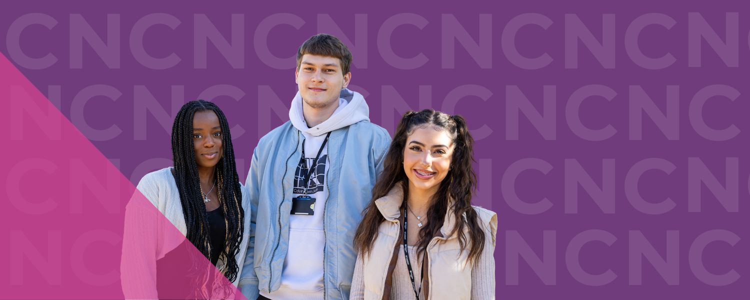 Image shows three students smiling to camera.