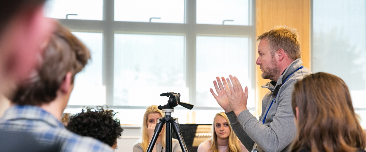 Media teacher demonstrating equipment to the class