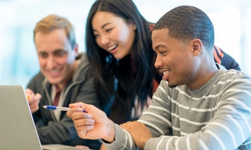 Students laughing at laptop