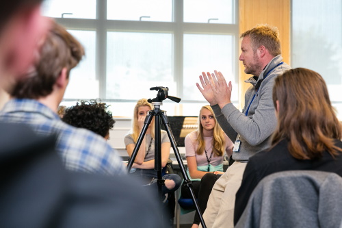 teacher explaining in front of a group